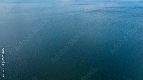 Aerial view of the blue waters of the Mediterranean Sea and specifically the Tyrrhenian Sea. Sunlight reflects on the surface of the water.