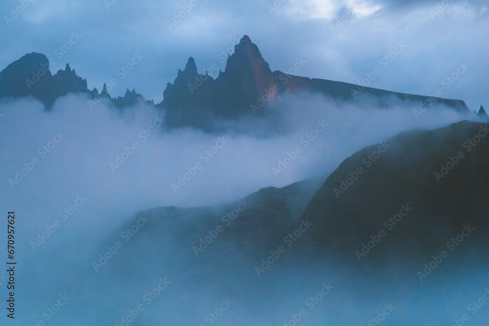 Foggy mountains landscape in Norway clouds and rocks scandinavian nature beautiful travel destination blue hour