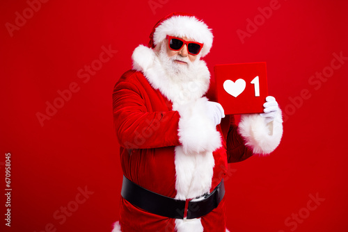 Photo of popular blogger grandfather wear trendy santa costume demonstrate social media like icon isolated on red color background