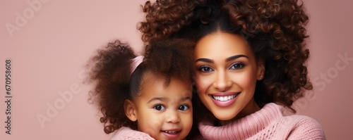 Mother and daughter hugging each other, smiling. Emotional portrait of a Mother and a daughter on soft colored wall.