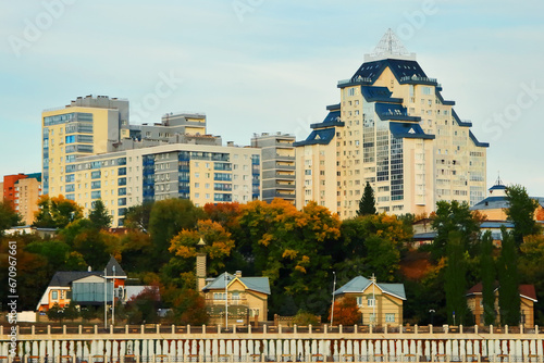 Beautiful view of the city from the Belaya River to the city of Ufa. Motor ships, boats on the water.Translation of the text - "Discounts on an apartment in Ufa".Bashkiria, Russia.Ufa. 