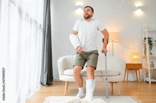 Obraz na plátně Recovery after physical injury in accident at home: Sad unlucky young man with b