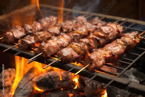 lamb kebabs on a rusted grill, smoky charcoal underneath
