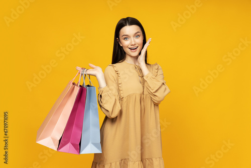 Smiling attractive young woman with shopping bags