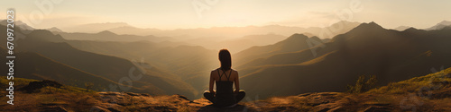 Woman sitting on hilltop, meditating amongst the misty graduating hills, while Sun is setting. © David
