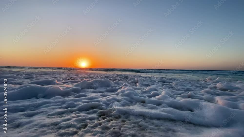 low angle view of sunset with sea waves low angle view of sunset with sea waves