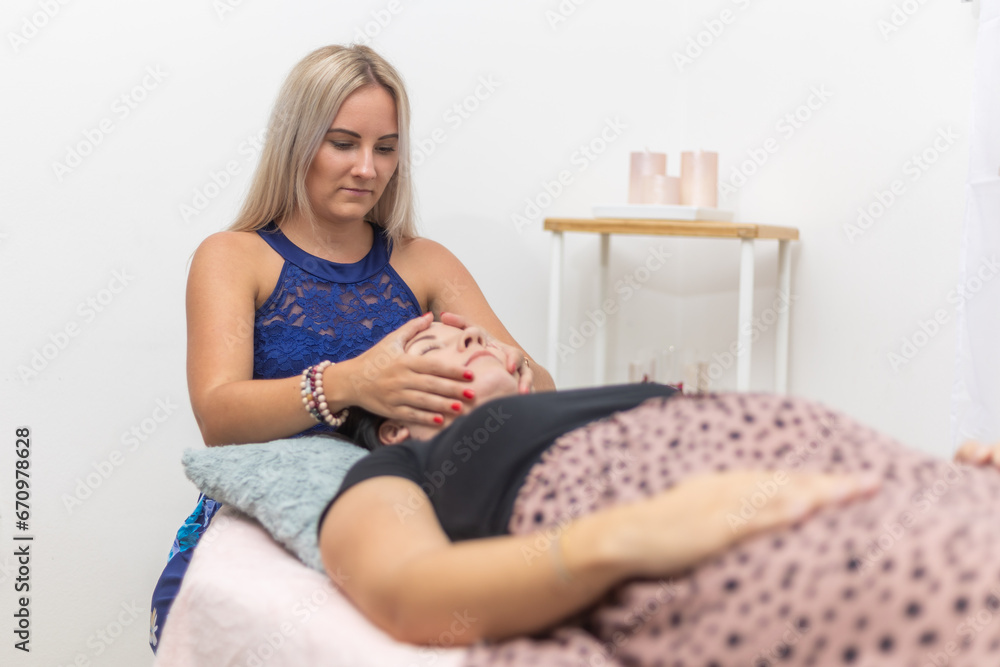 Woman healer performing and seeking access or consciousness bars to cure diseases or heal injuries by means other than conventional medical treatment, an alternative medicine Woman healer performing and seeking access or consciousness bars to cure diseases or heal injuries by means other than conventional medical treatment, an alternative medicine