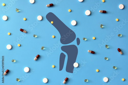 The silhouette of the joint surrounded by pills. Treatment of joint diseases