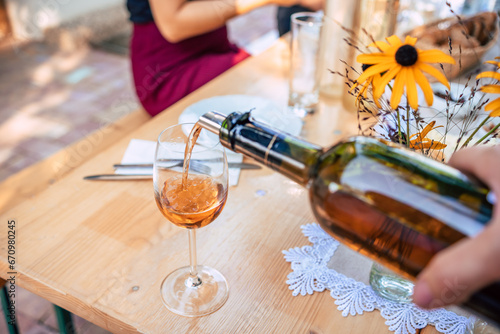 A person pouring wine to a glass