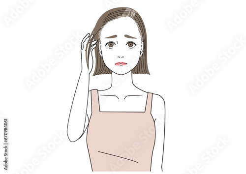 根元の白髪が伸びて困っている表情の女性