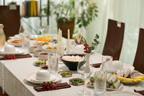 Bowl of rice and various snacks on dinner table