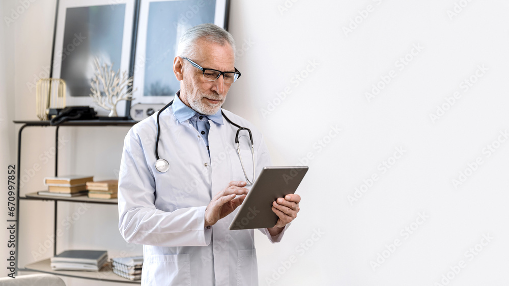 doctor man using online app on computer tablet in clinic cabinet doctor man using online app on computer tablet in clinic cabinet