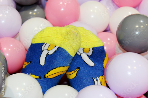 egs of a girl in funny blue socks with bananas in balls for a dry pool