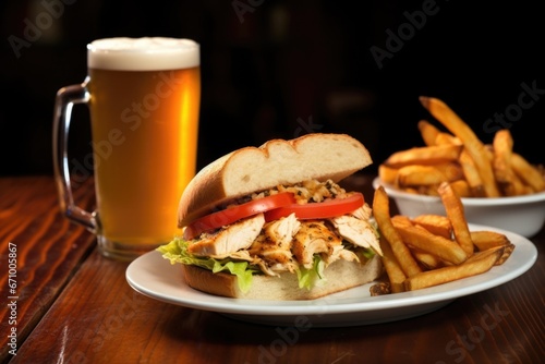grilled chicken sandwich next to a frosty mug of light beer