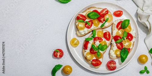Fresh bread sandwiches with tomato cherry, cream cheese and basil leaves. Morning breakfast concept