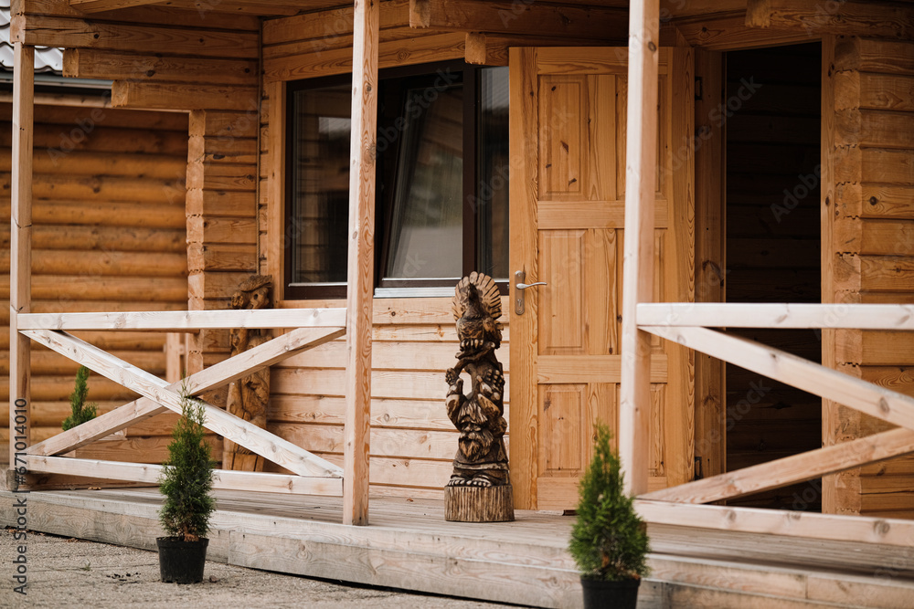 Porch and open doors of a wooden house. Concept of buying an ecological house made of wood Porch and open doors of a wooden house. Concept of buying an ecological house made of wood