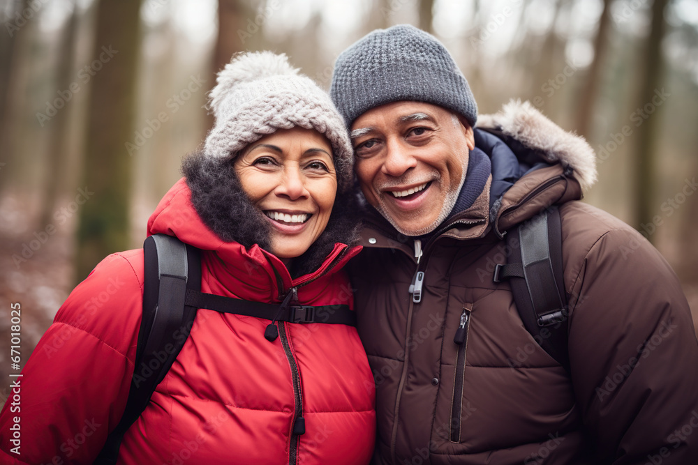 Middle age mixed race couple enjoying outdoors activity in winter forest