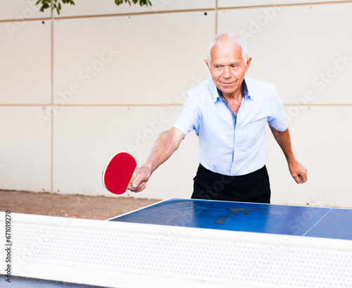 Mature man playing table tennis