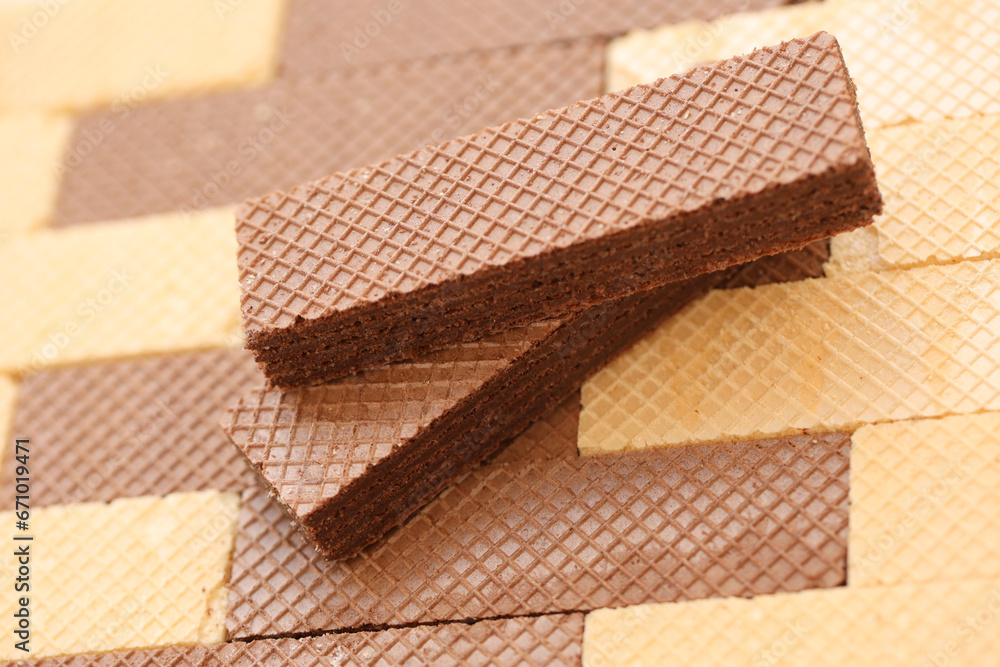Stacked delicious chocolate wafers in large amount. Two different flavours of classic small waffles Stacked delicious chocolate wafers in large amount. Two different flavours of classic small waffles
