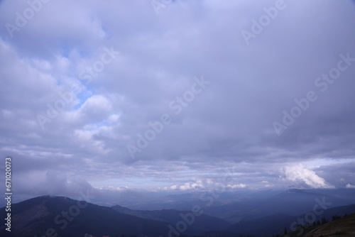 Morning view from the Dragobrat mountain peaks in Carpathian mountains, Ukraine. Cloudy and foggy landscape around Drahobrat Peaks in early morning
