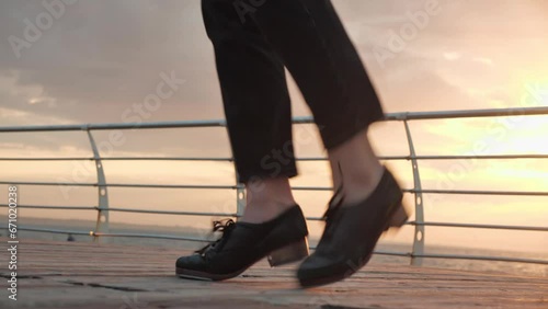 tap dancing person with sunrise sea view. Irish dancing. dancing shoes on legs photo