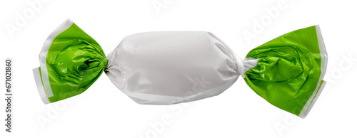 Candy wrapped with green and white paper, close up isolated