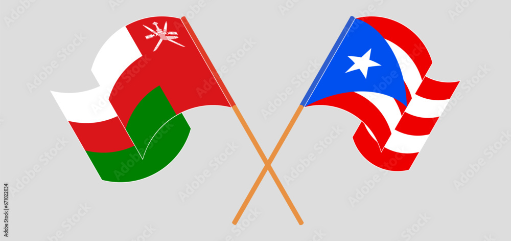 Crossed and waving flags of Oman and Puerto Rico