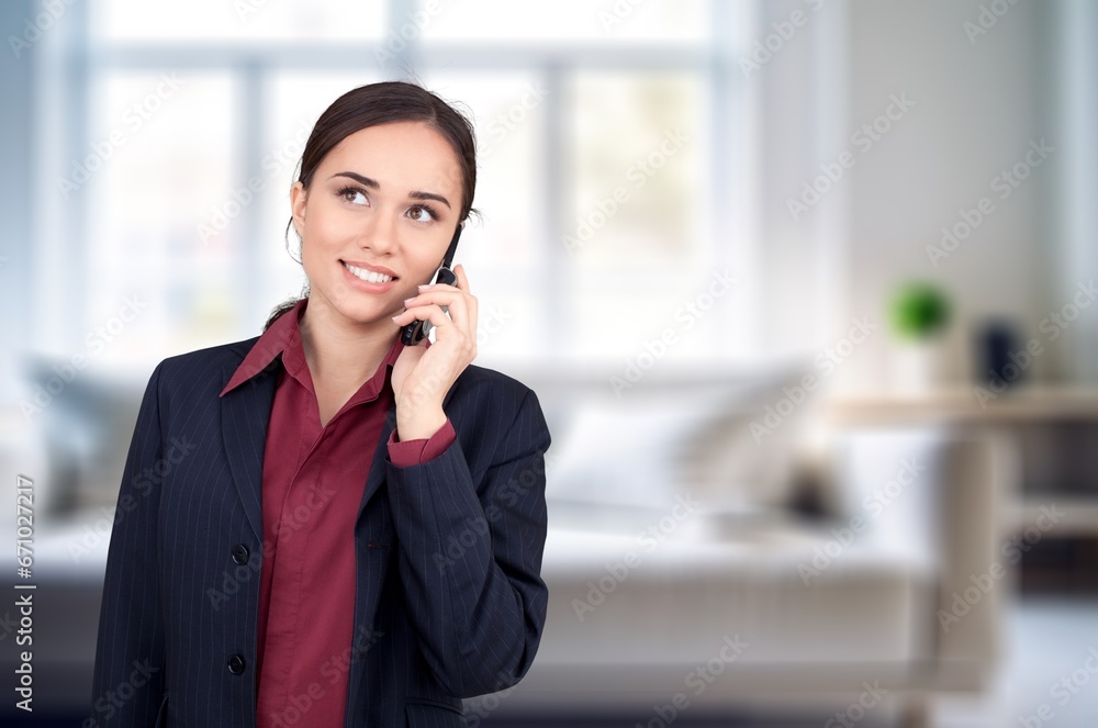 Young businesswoman holding smartphone in modern office, AI generated image Young businesswoman holding smartphone in modern office, AI generated image