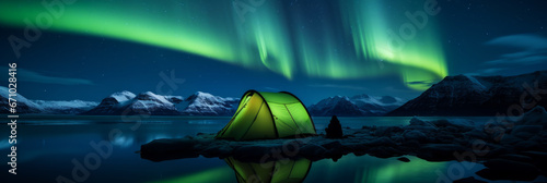 A camping tent glowing under the northern lights, Aurora Borealis. Travel and adventure © ink drop