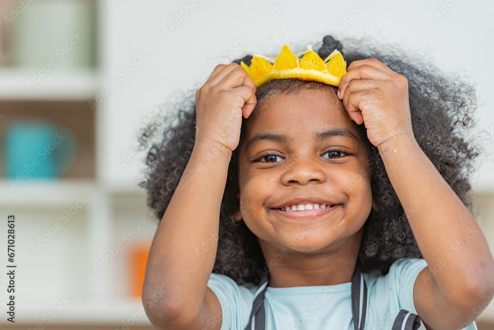 african afro hair black kid Cute ginger hold covering eye with half sliced oranges smile enjoy
