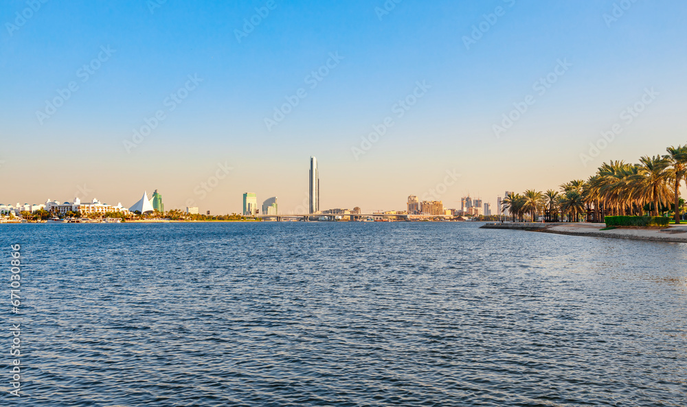 Dubai Creek bay with skyscrapers and palm trees in UAE