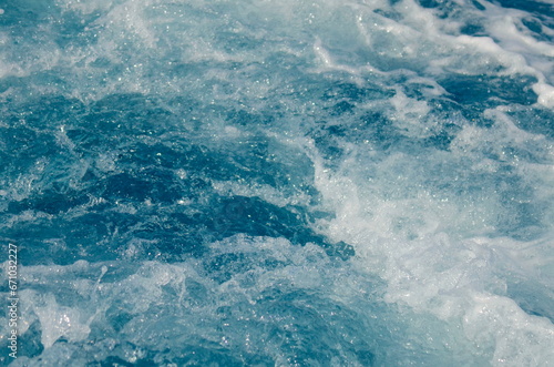 Stormy sea, strong waves. A trace on the sea from a boat or yacht. Ocean close-up, beautiful water color