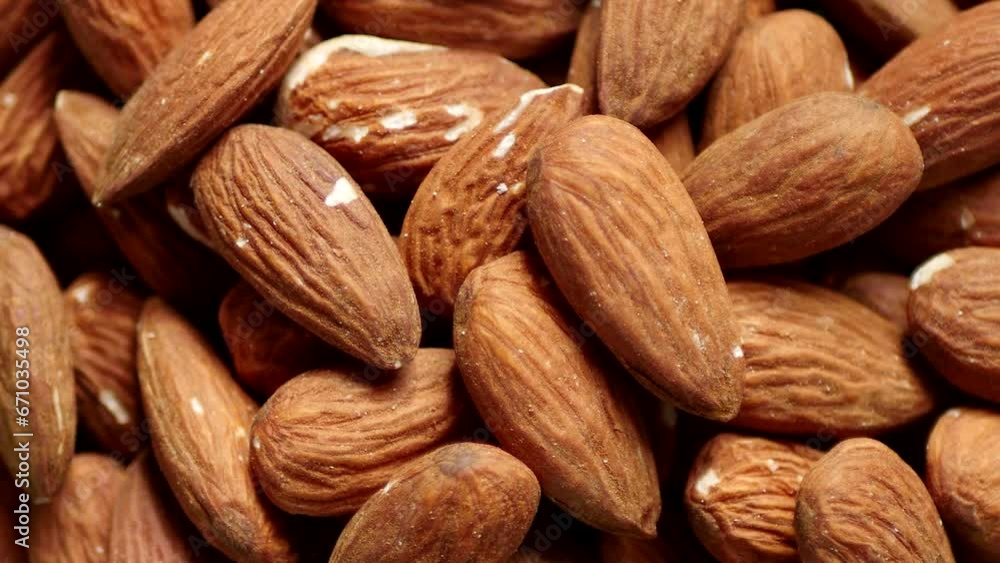Almonds heap rotating. Nut background. Vegan diet Almonds heap rotating. Nut background. Vegan diet