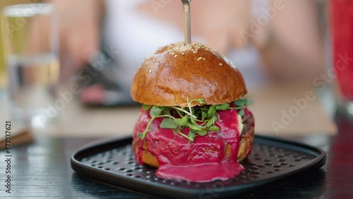 Close up burger with red sauce and green salad microplants photo