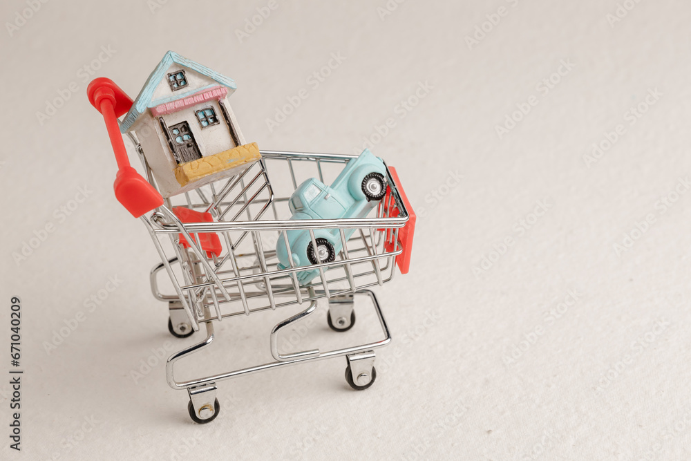 shopping cart and house model in saving plan for residence of people in society, purchasing home for living of dream of community lives