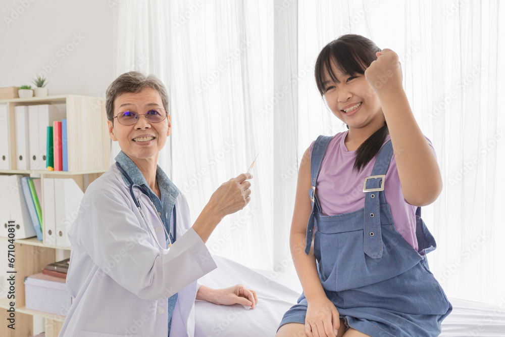 doctor inject vaccine to asian girl, girl feeling happy and show cheerful sign with hand, Deltoid muscle injection technique, children immunization and health care promotion doctor inject vaccine to asian girl, girl feeling happy and show cheerful sign with hand, Deltoid muscle injection technique, children immunization and health care promotion