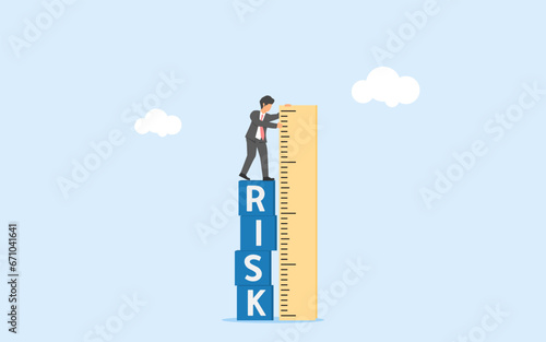 Risk assessment and management. Analayzing risk and consequence. Minimizing danger and failure. Businessman measures risk with a ruler