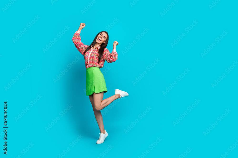 Full length photo of young lady wear mini skirt celebrating her victory at tango dance competition isolated on cyan color background Full length photo of young lady wear mini skirt celebrating her victory at tango dance competition isolated on cyan color background