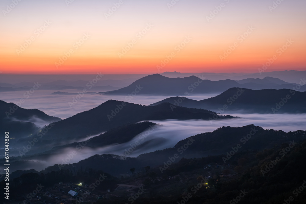 Scenic view of morning fog and mist against sky during sunrise