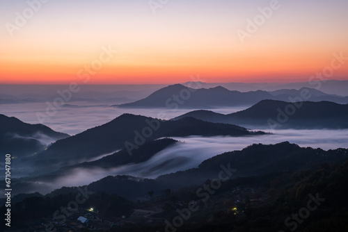 Scenic view of morning fog and mist against sky during sunrise © Sangoh