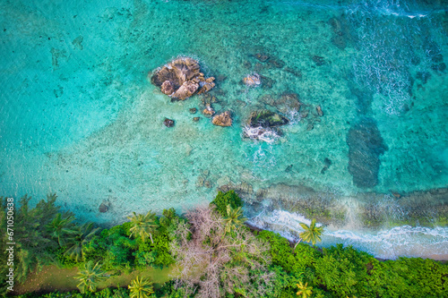 Bird eye drone of Port Glaud beach, granite stones, white sandy beach, turquoise water, coconut palm, greenery, trees, sunny day, Mahe Seychelles 1
