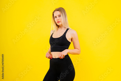 Young woman, posing in the studio. Advertising sportswear and yoga wear. Healthy lifestyle, sport