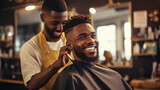 Barber giving a stylish haircut in his shop, African American, blurred background, with copy space
