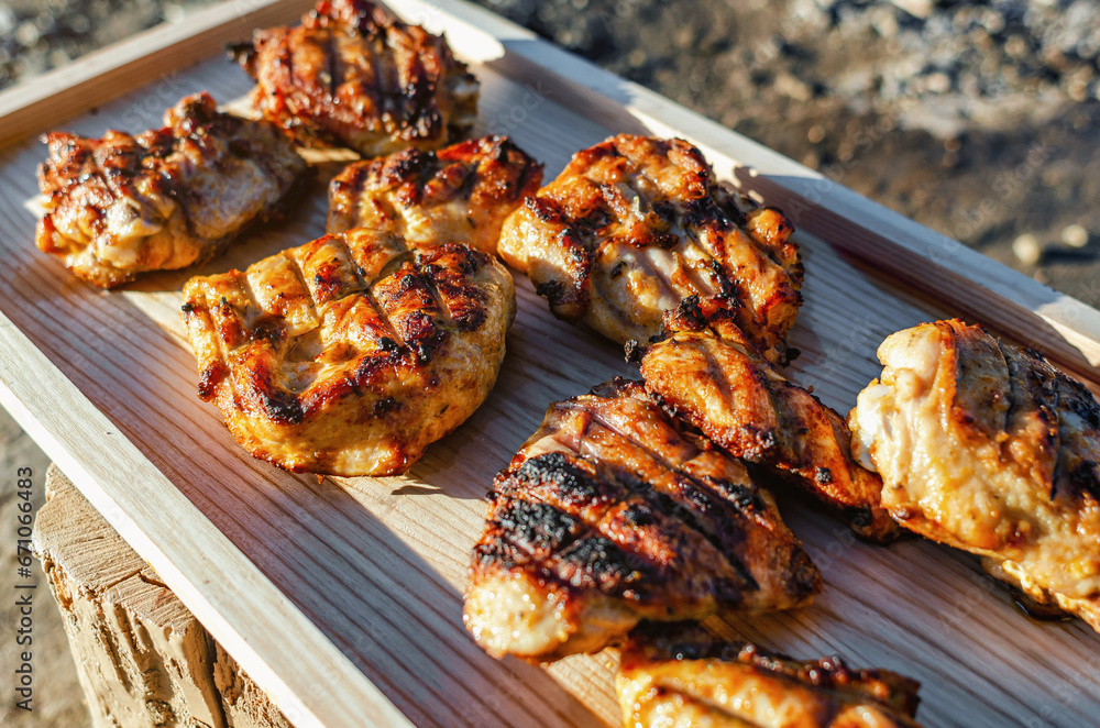 Succulent Chicken Cuts Glistening in Sunlight, Resting on Rustic Wooden Board for a Culinary Spectacle