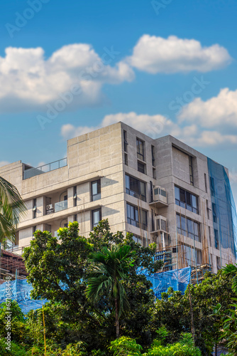 A beautiful under construction White build in Bangladesh with tree and clear sunny sky background