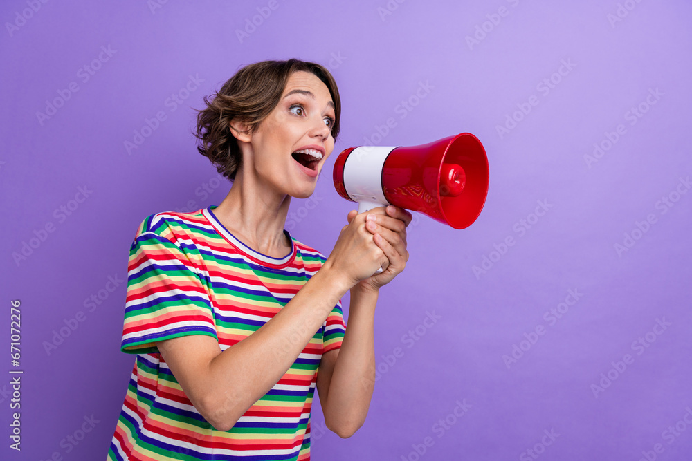 Photo of excited cheerful girl hold bullhorn look empty space announce special news isolated on purple color background Photo of excited cheerful girl hold bullhorn look empty space announce special news isolated on purple color background