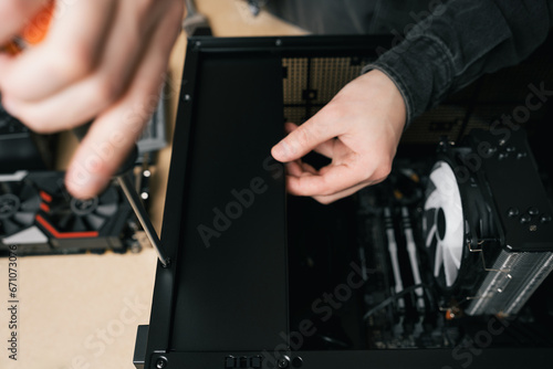 Computer technician installs cooling system of computer. Assembling PC 