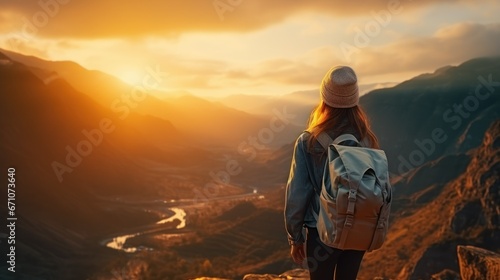 Young woman traveler taking photo with smartphone at sea of mist and sunrise over the mountain.
