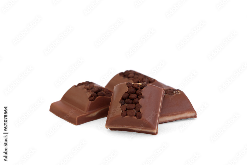 Pieces of milk chocolate with filling and decorated with crumbs isolated on white background.