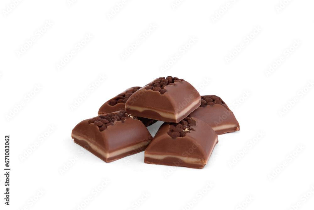 Pieces of milk chocolate with filling and decorated with crumbs isolated on white background. Pieces of milk chocolate with filling and decorated with crumbs isolated on white background.
